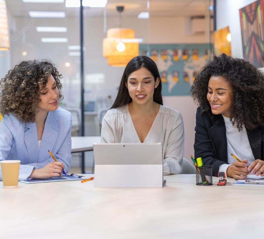 Mujeres empresarias reunidas y un tablet comprimida
